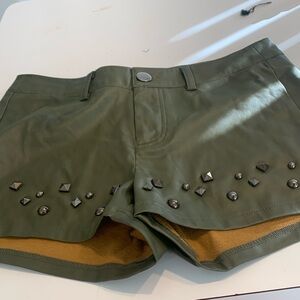 Green leather shorts with black stones